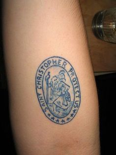 a tattoo on the arm of a person with a blue and white logo in it