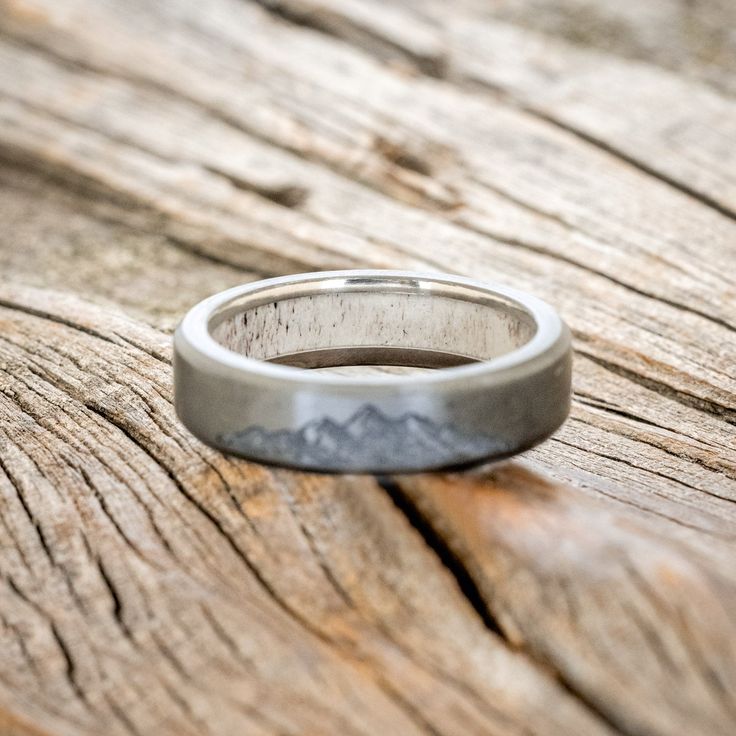 a wedding ring sitting on top of a wooden table