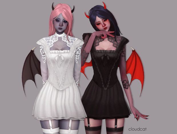 two women dressed in gothic clothing with bats on their shoulders