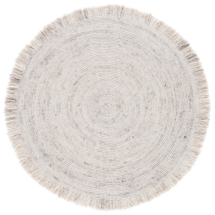 a round rug with fringes on the bottom in white and beige colors, isolated against a white background