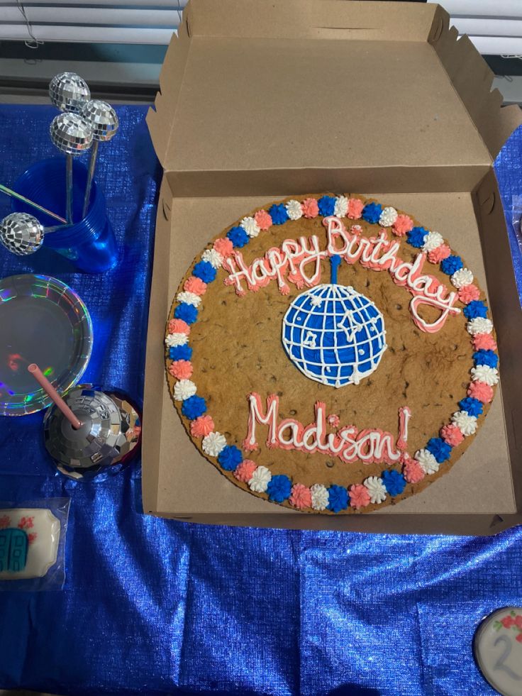 a birthday cake with the words happy birthday madison in pink, blue and white frosting