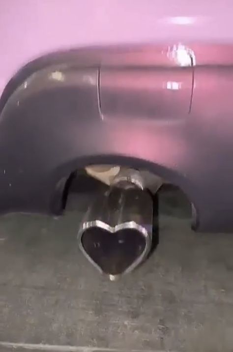 there is a heart shaped hole in the side of a purple car's bumper