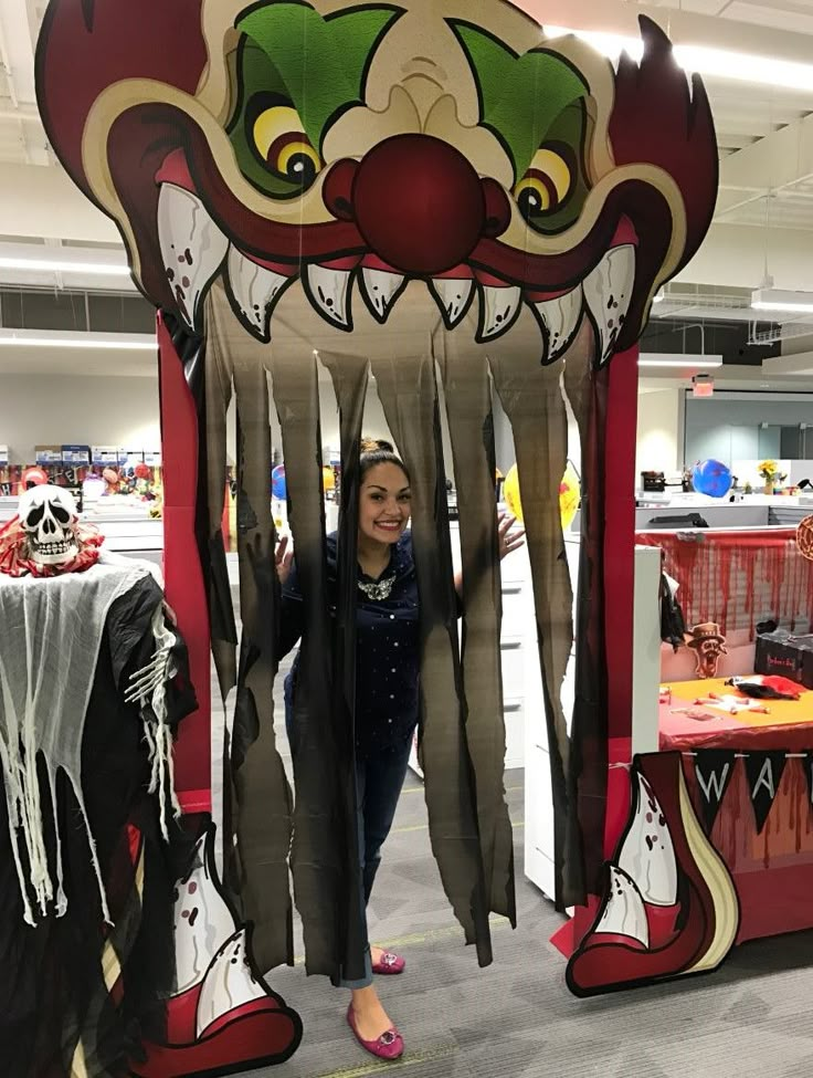 a woman is standing in front of a fake mask