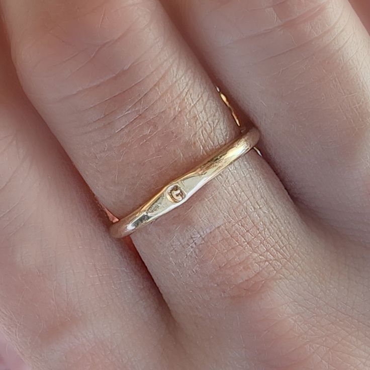 Adorn you hands with this timeless Minimal Initial Signet Ring. Hand-crafted from 14K yellow gold filled, this ultra-chic ring is a perfect gift for moms or couples. It's a unique, minimal piece with the power to carry a special, sentimental message. Rings are handmade in our Indiana studio. There will be a small color difference in the gold where it is soldered together in our studio. Please add initial in the NOTES box at checkout. Minimalist Recycled Gold Stackable Rings For Anniversary, Simple 14k Gold Engraved Ring For Anniversary, Simple Initial Ring As Gift, Minimalist Gold Stackable Rings For Anniversary, Simple Yellow Gold Stackable Rings As Gift, Simple Yellow Gold Stackable Promise Rings, Minimalist Stackable Initial Ring For Anniversary, 14k Gold Simple Initial Promise Ring, Adjustable Yellow Gold Initial Ring