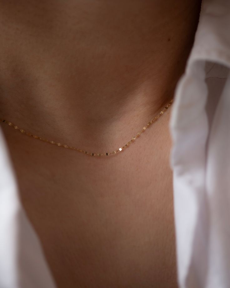 Add a touch of sparkle to any outfit with our Dainty Glitter Chain Necklace. The delicate chain captures the light in a beautiful way, making it a versatile piece to wear alone or layer with other necklaces. Embrace a subtle, yet glamorous look with this glitter daped chain. 14k Gold Spring ring clasp Dainty Charm Necklaces For Party, Dainty Yellow Gold Necklaces For Party, Dainty Yellow Gold Chain Necklace For Party, Dainty Yellow Gold Necklace For Party, Dainty Yellow Gold Party Necklace, Minimalist Charm Necklace For Party With Delicate Chain, Delicate Charm Necklaces For Parties, Minimalist Yellow Gold Chain Necklace For Party, Minimalist Charm Necklace For Party