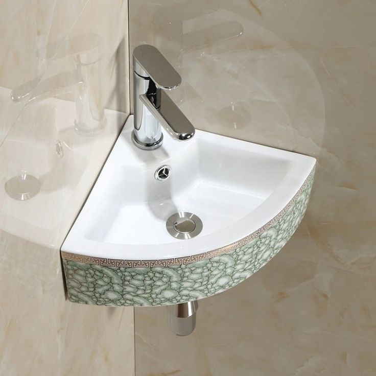 a bathroom sink with a chrome faucet and soap dispenser on the wall