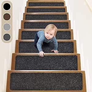 a baby is crawling down the stairs with his hands on the carpet and looking at the camera