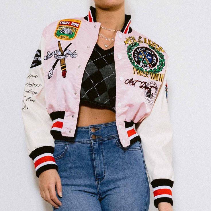 Satin Cropped Varsity Jacket Featuring Embroidered Patches And Faux Leather Sleeves. White Embroidered Varsity Jacket For College, Spring Varsity Jacket With Patchwork, Fall White Outerwear With Embroidered Logo, White Floral Embroidery Outerwear For Fall, Retro Embroidered Varsity Jacket For Fall, Embroidered Retro Varsity Jacket For Fall, Spring Varsity Jacket With Embroidered Logo, White Varsity Jacket With Embroidered Logo For Winter, Patchwork Varsity Jacket For Spring