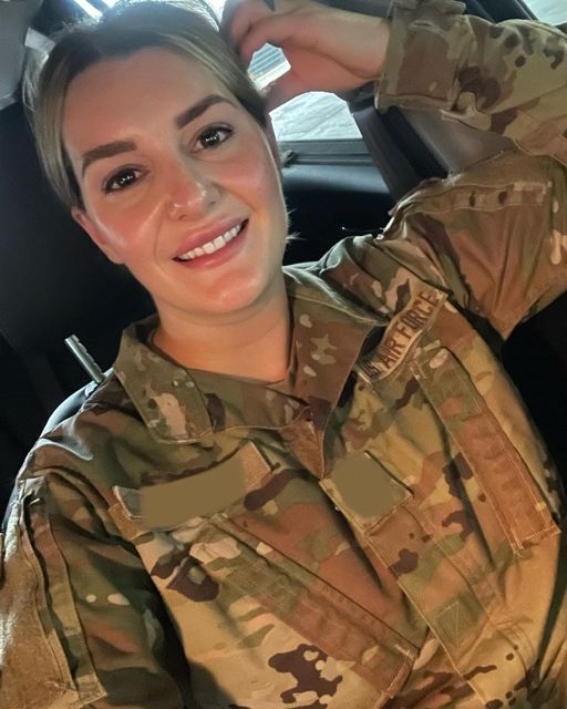 a woman in uniform is smiling for the camera