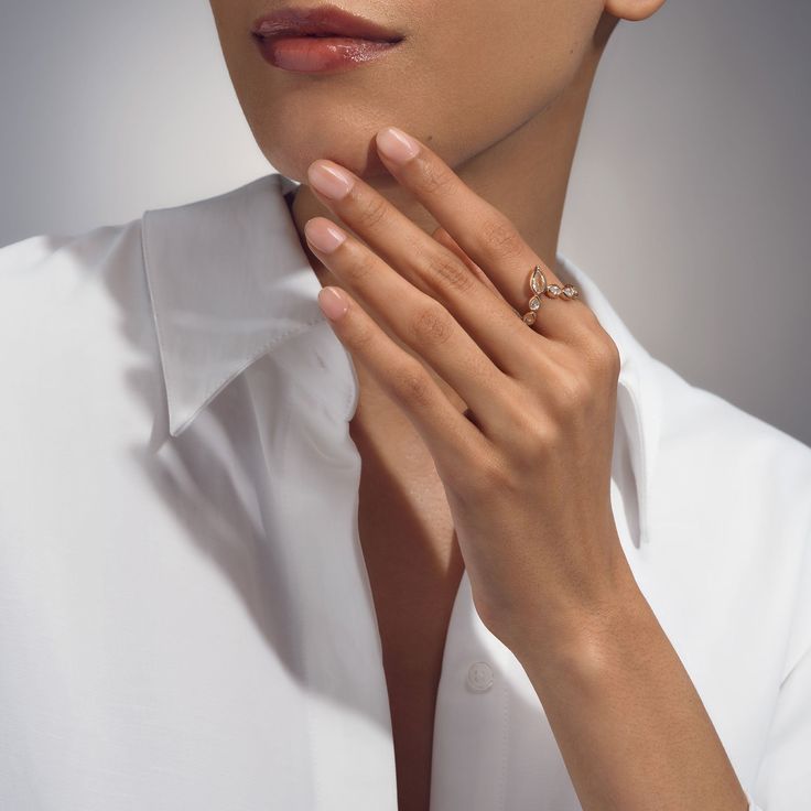 a woman in white shirt holding her hands together