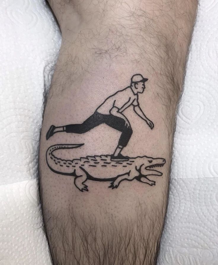 a man riding on top of an alligator tattoo