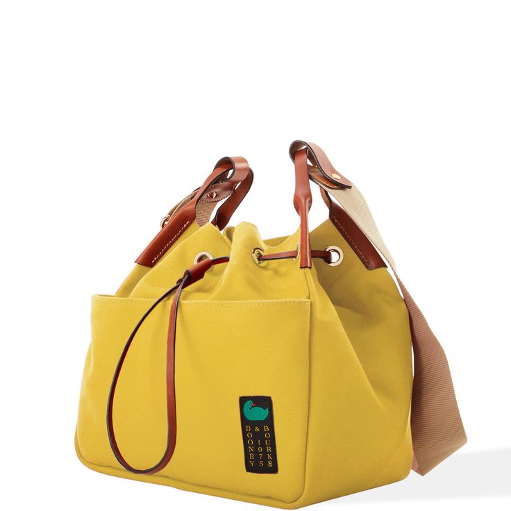 Keeping It Casual  This casual-chic look is crafted from 100% Egyptian cotton. With effortless Dooney flair and so many functional additions, this is the perfect every day bag! Canvas Bucket Bag With Adjustable Strap, Canvas Crossbody Bucket Bag For Errands, Canvas Pouch Bucket Bag With Adjustable Strap, Yellow Canvas Shoulder Bag With Removable Pouch, Yellow Canvas Shoulder Bag With Double Handle, Canvas Bucket Satchel With Detachable Handle, Canvas Satchel Bucket Bag With Detachable Handle, Canvas Hobo Bag With Detachable Strap For Travel, Canvas Bucket Bag With Detachable Handle As Satchel