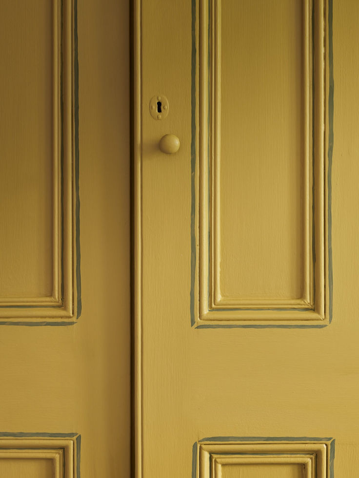 the door is painted yellow and has two cats on it