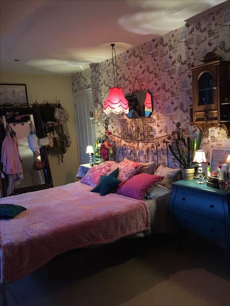 a bed room with a neatly made bed and lots of decorations on the headboard