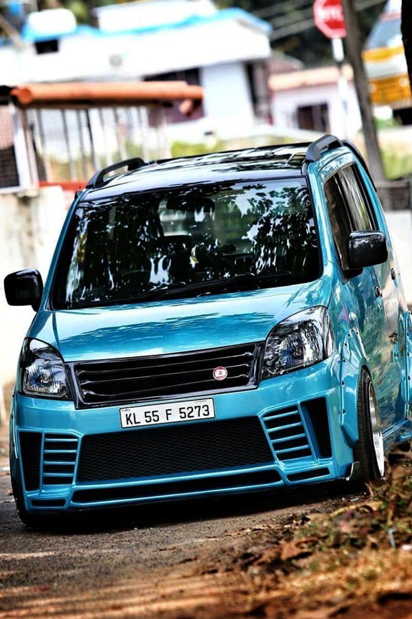 a blue car parked on the side of a road