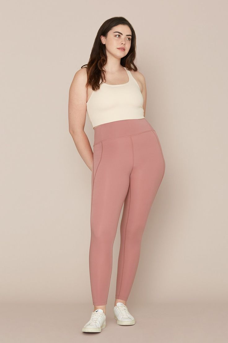 a woman wearing pink pants and white top