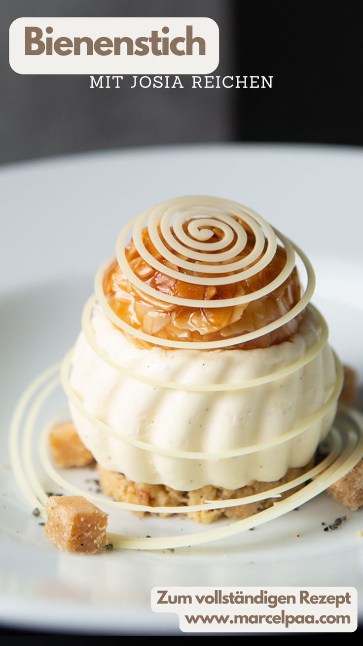 a white plate topped with a pastry covered in icing