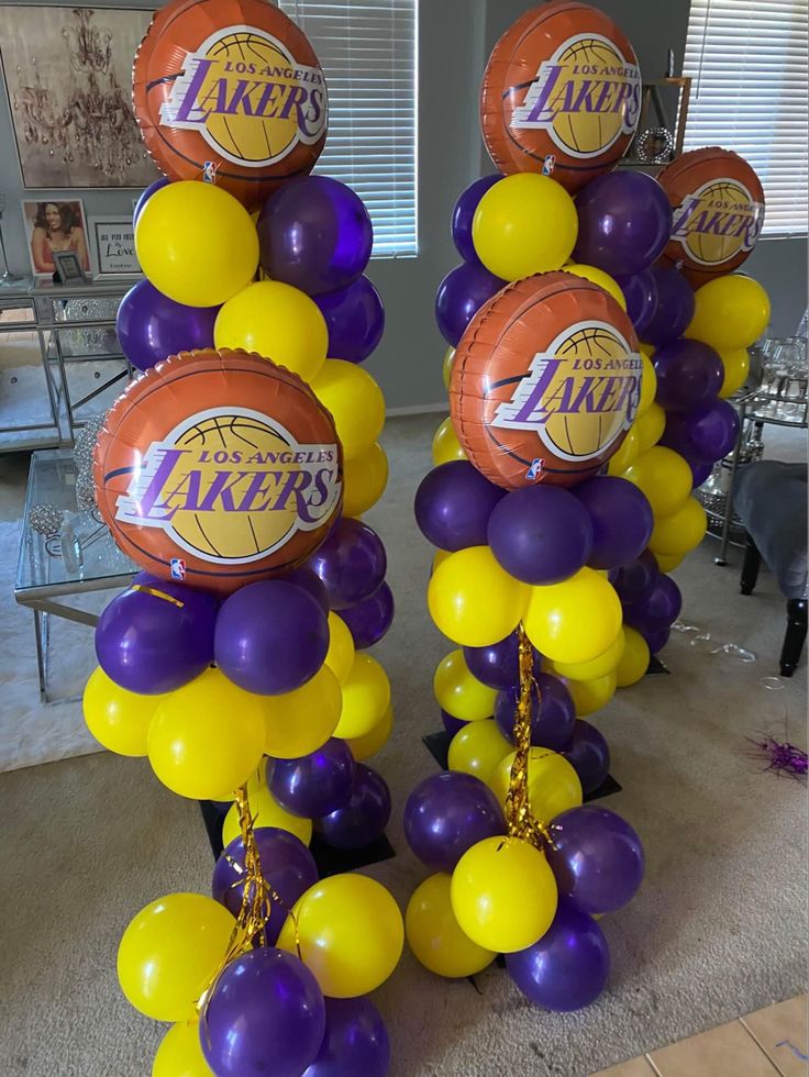 balloons and basketballs are arranged in the shape of lakers's logo on top of each other