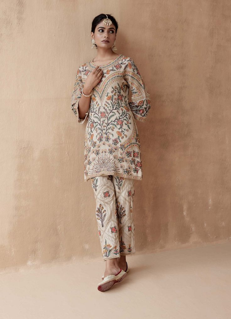 Editor's Note Introducing an elegant ivory kurta adorned with intricate floral thread embroidery, beautifully highlighted with various embellishments. This exquisite piece is paired with pants, creating a graceful and sophisticated ensemble perfect for special occasions or cultural events. The delicate embroidery and thoughtful embellishments add a touch of charm, making this outfit a stunning choice for those who appreciate timeless beauty and style. Fabric: Pure georgette Color: Ivory Componen Luxury Floral Embroidered Party Kurta, Luxury Festive Floral Embroidered Kurta, Transitional Cream Kurta With Floral Embroidery, Designer Cream Kurta With Floral Embroidery, Chanderi Cream Sets With Floral Embroidery, Cultural Events, Indian Design, Bridal Couture, Handmade Clothes