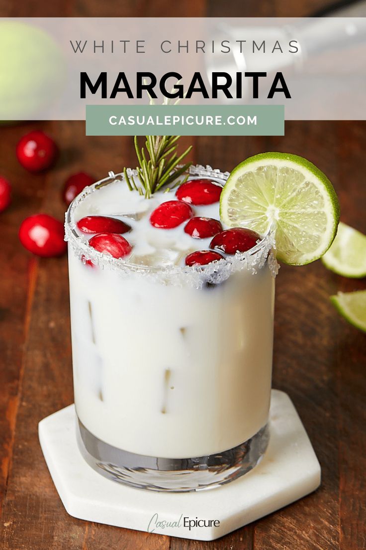 a white christmas margarita with cranberries and lime