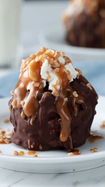 a chocolate dessert with caramel drizzled on top and coconut flakes