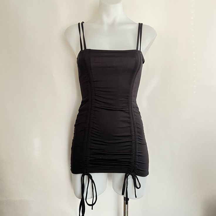 Good Condition. Stitching On Drawstring Loose As Pictured. Club Mini Dress With Ruched Sides, Black Mini Dress With Ruched Back For Summer, Solid Color Ruched Mini Dress For Club, Black Fitted Mini Dress With Drawstring, Fitted Black Mini Dress With Drawstring, Chic Bodycon Mini Dress With Drawstring, Summer Black Ruched Bodycon Dress, Casual Ruched Bodycon Dress For Club, Black Drawstring Dress For Party