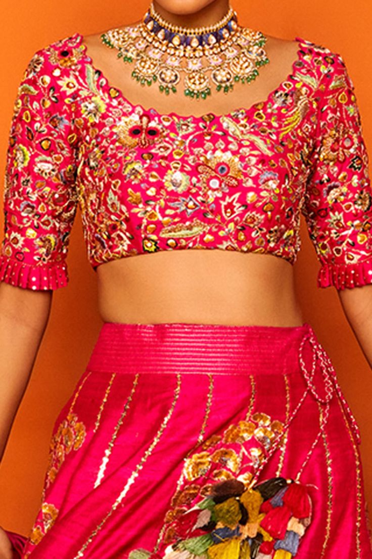 Fuchsia pink lehenga  hand embroidered with clusters of petals in gotapatti and sequined knots forming paisley motifs. Comes with cutwork blouse enhanced with mirrors, gotapatti, sequined knots and  ombre silk dupatta in shades of fuchsia and coral orange.
Components:3
Embroidered
Neckline:Round
Sleeve Length:Half
Fabric:Chanderi silk, raw silk, Tusser Silk
Color:Pink
Tassel dupatta
Pleated sleeve hem
Kamar latkans
Note: Red lehenga set worn by the model to the left is not for sale - Aza Fashion Pink Blouse Piece With Zari Work For Reception, Festive Pink Pre-draped Dola Silk Saree, Pink Pre-draped Saree With Resham Embroidery For Festive Occasions, Festive Pink Dola Silk Blouse Piece, Festive Pink Blouse Piece For Reception, Pink Dola Silk Choli With Zari Work, Pink Kundan Traditional Wear For Reception, Pink Anarkali Blouse Piece With Zari Work, Pink Art Silk Choli With Dori Work