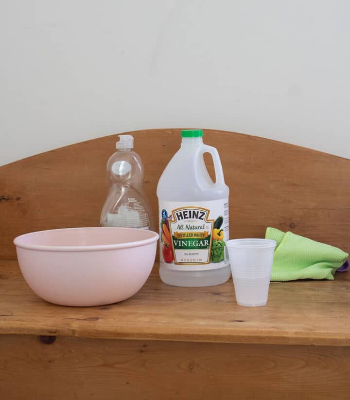 a wooden table topped with bowls and bottles