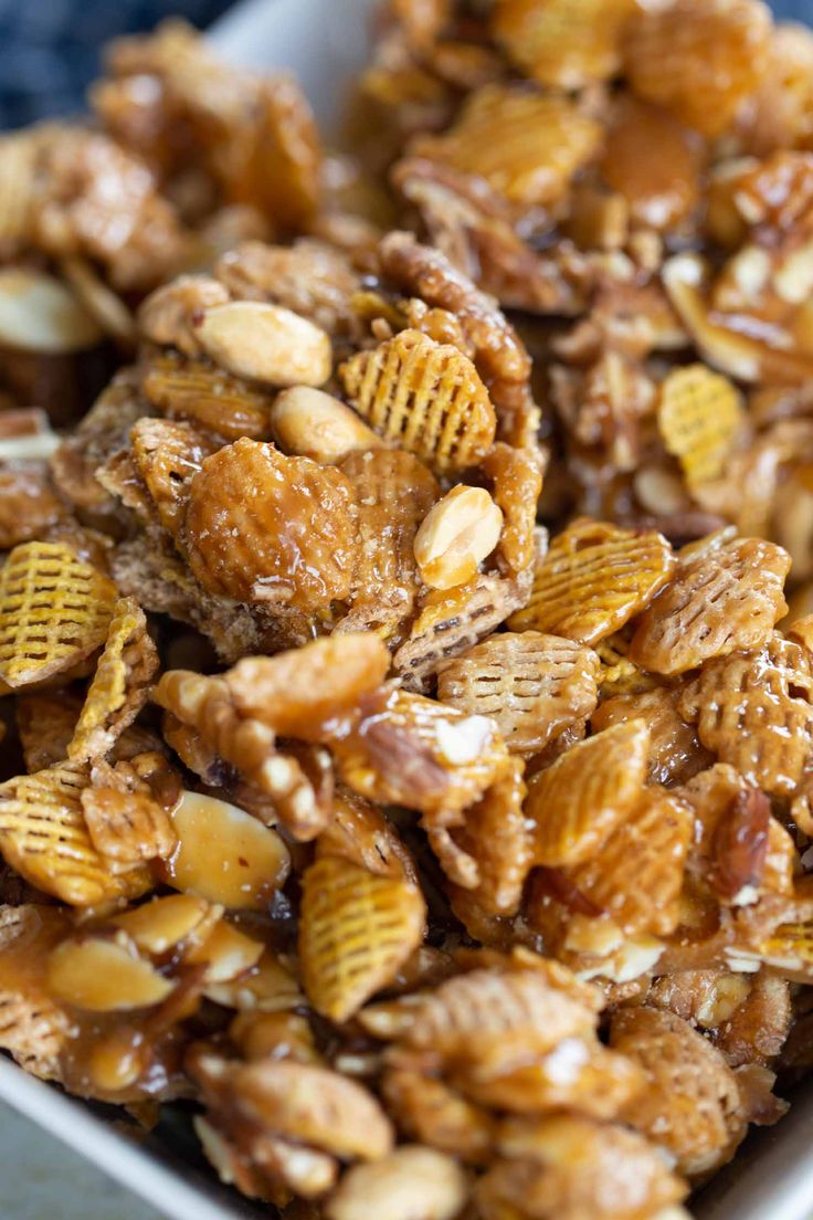 a bowl filled with cereal and nuts on top of a table