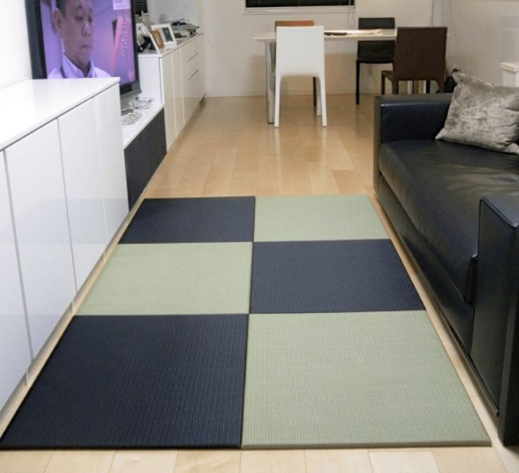 a living room filled with furniture and a flat screen tv mounted to the side of a wall