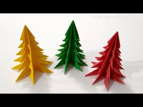 three origami christmas trees sitting next to each other