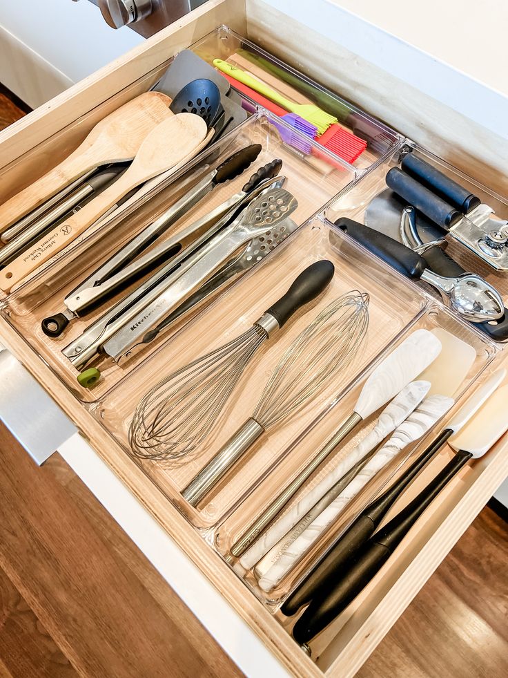 Kitchen utensils organized in a drawer with clear organizers Large Utensil Drawer Organization, Kitchen Cooking Utensil Organization, Utensil Storage Drawer, Kitchen Drawer Organization Utensils, Organizers For Kitchen, Utensils Drawer, Cooking Utensil Organization, Acrylic Drawer Organizer, Office Drawer Organization