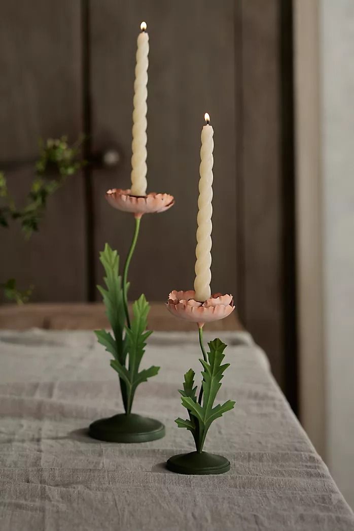 two candles are sitting on top of a table