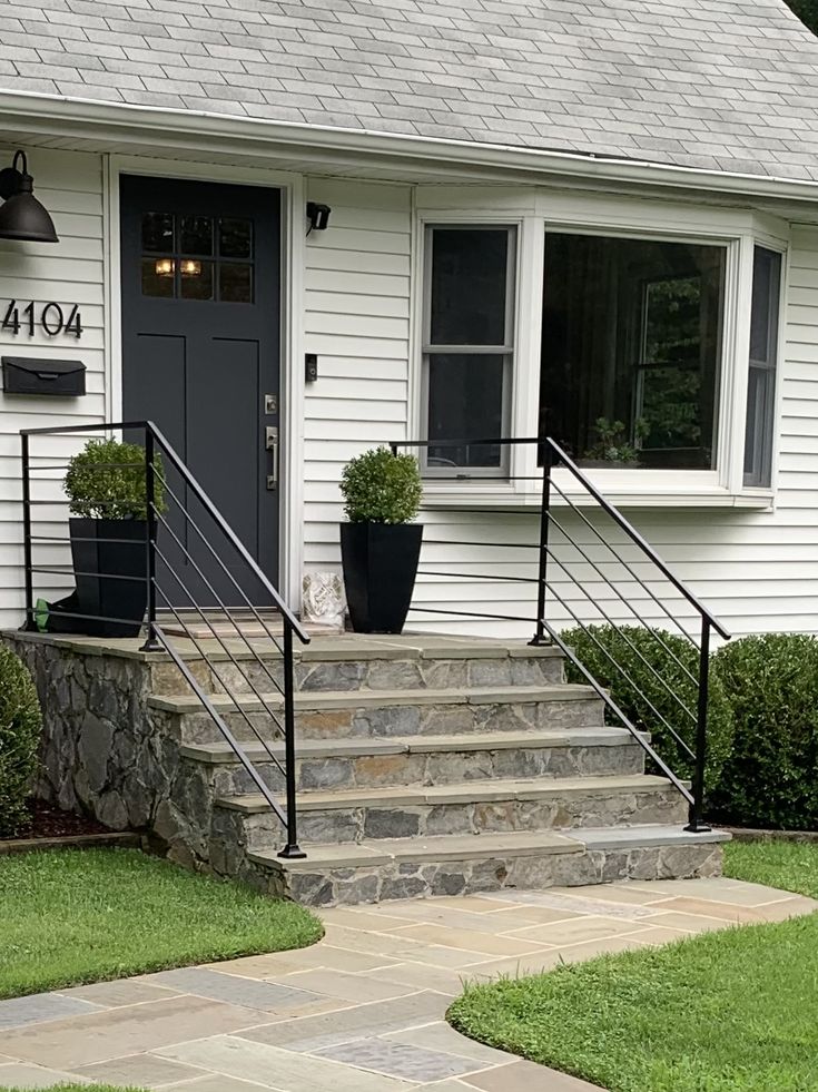 a white house with steps leading up to the front door