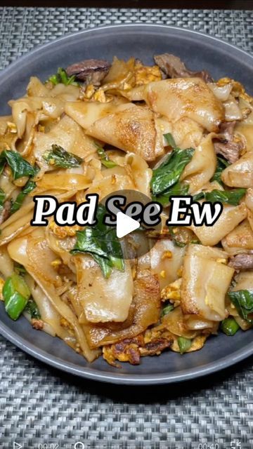 a plate full of food with the words pad see ew