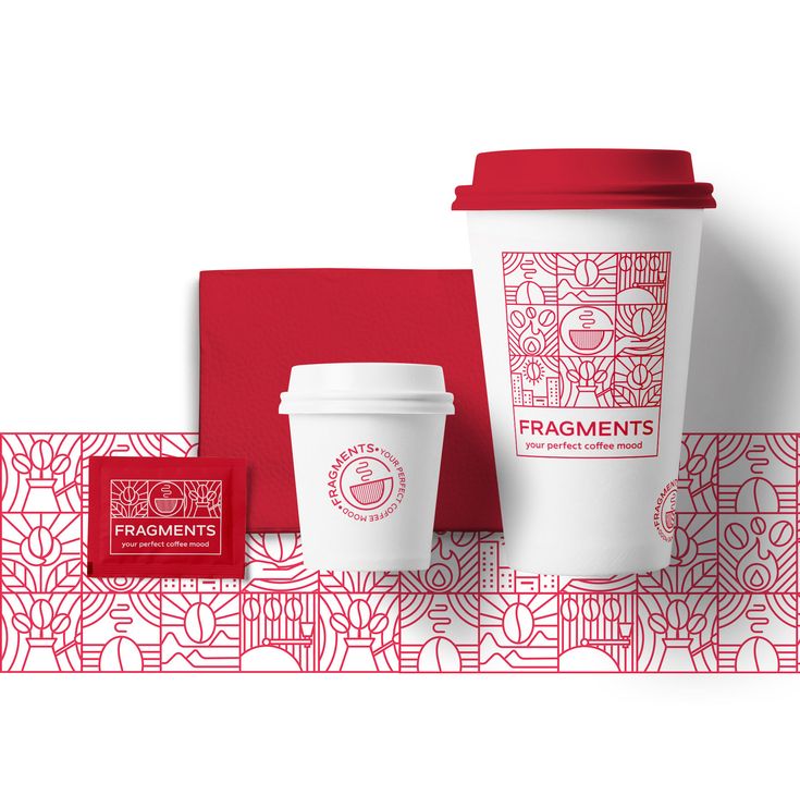 two coffee cups with red lids and matching napkins