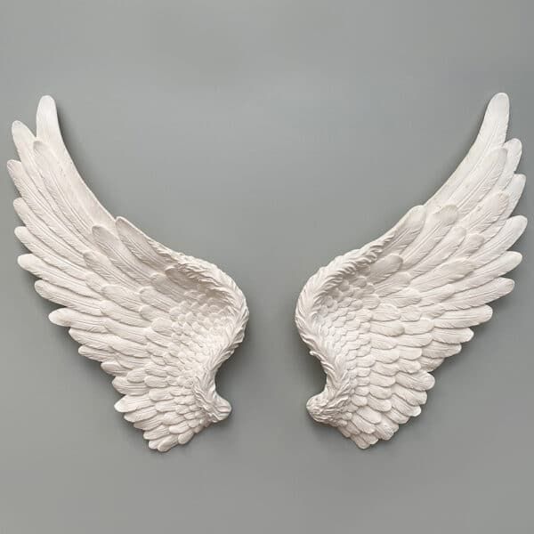 two white angel wings on a gray background