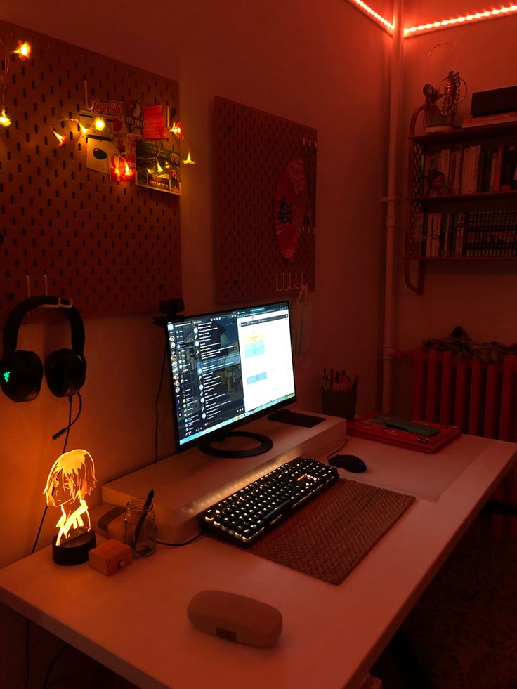 a desk with a computer and headphones on it