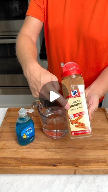 a person in an orange shirt is preparing food on a wooden cutting board with ingredients