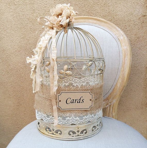 a birdcage with cards attached to it