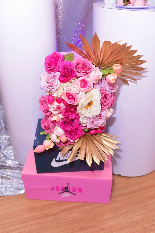 a bouquet of flowers sitting on top of a pink box