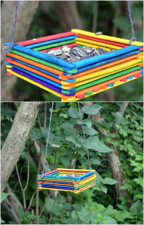 a bird feeder made out of colored sticks