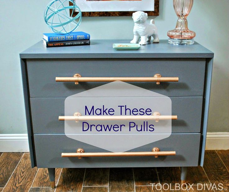 a gray dresser with wooden handles and two drawers