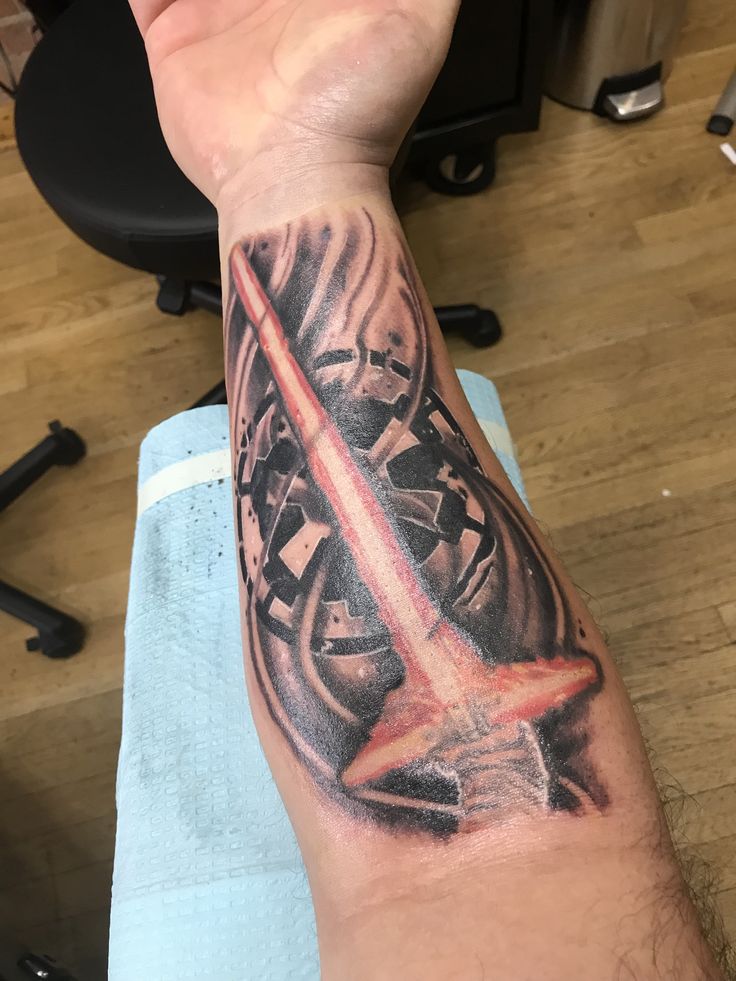 a man's arm with a star wars tattoo on it