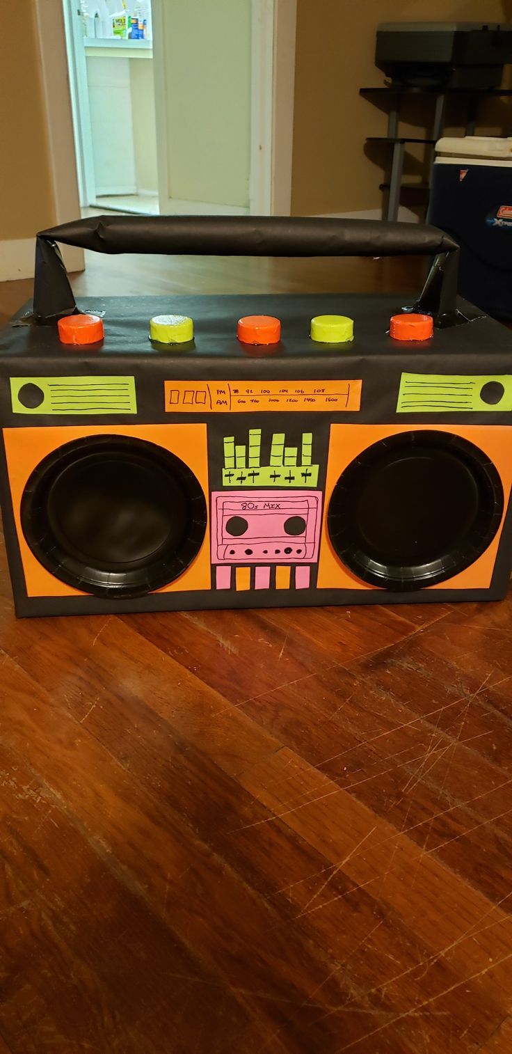 an old fashioned radio with speakers on top of it sitting on a hard wood floor