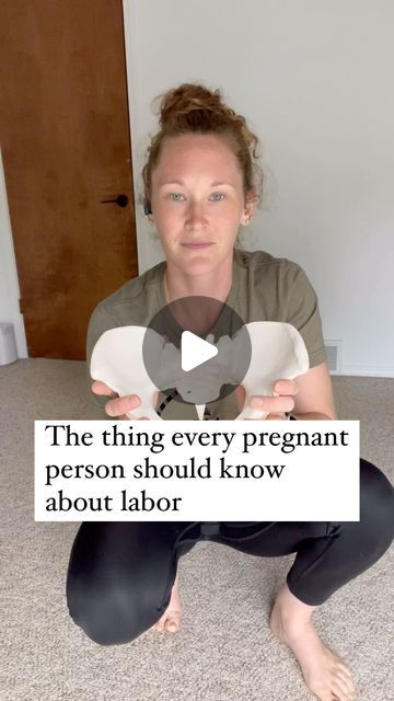 a woman is sitting on the floor holding a sign that says, the thing every pregnant person should know about labor