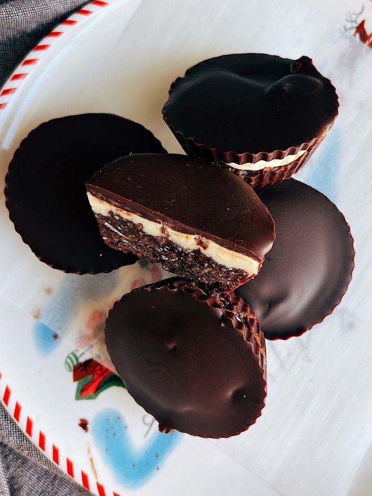 three chocolate covered desserts on a plate