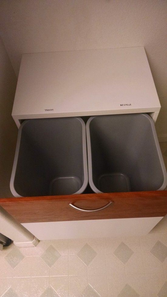 an open white box with two empty dishes in it sitting on a shelf above a sink