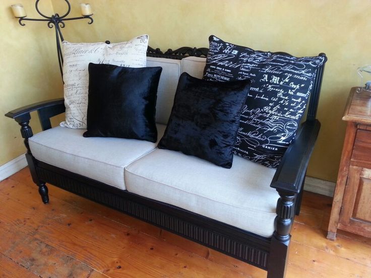 a couch with black and white pillows on it