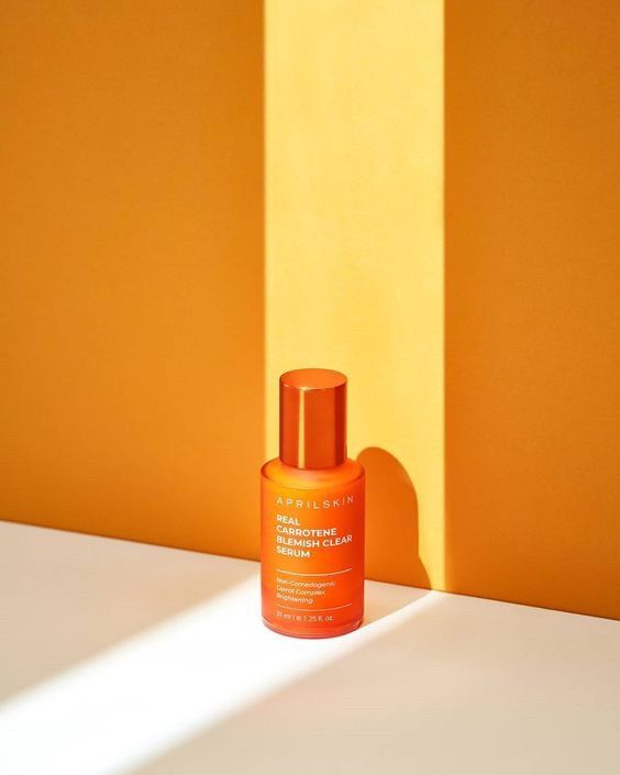 an orange bottle sitting on top of a white counter next to a yellow and orange wall